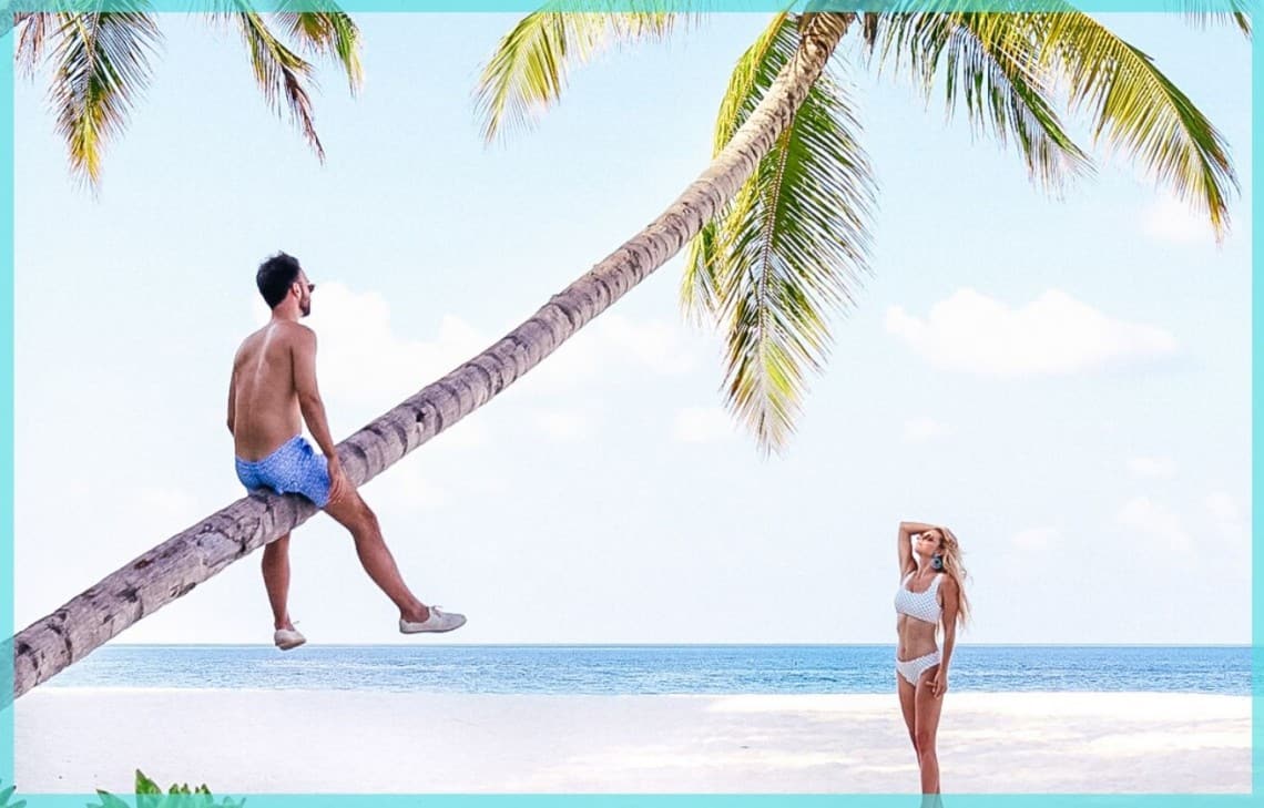 couple in the maldives with palm tree