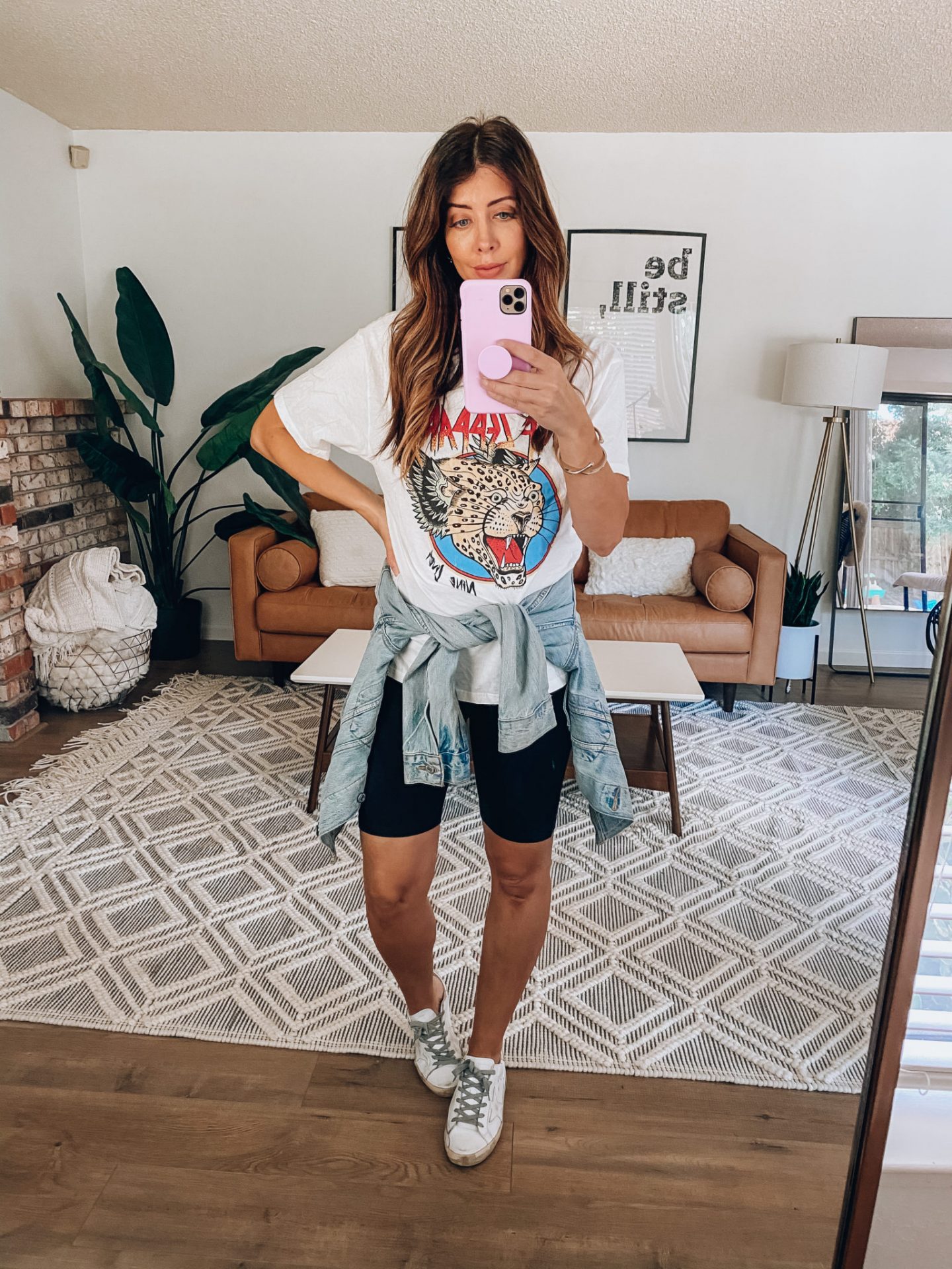 white sneakers with bike shorts and band tee