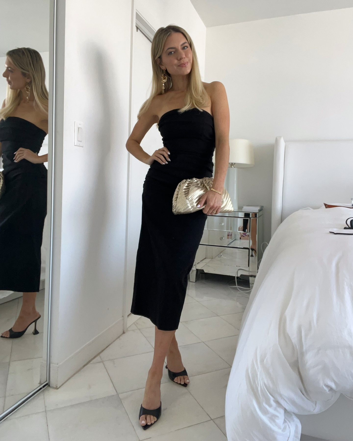 strapless black midi dress with black heels and gold clutch | What to Wear to a Summer Wedding