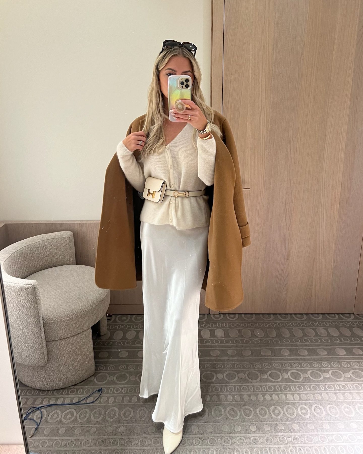 white silk skirt with white boots and a cardigan