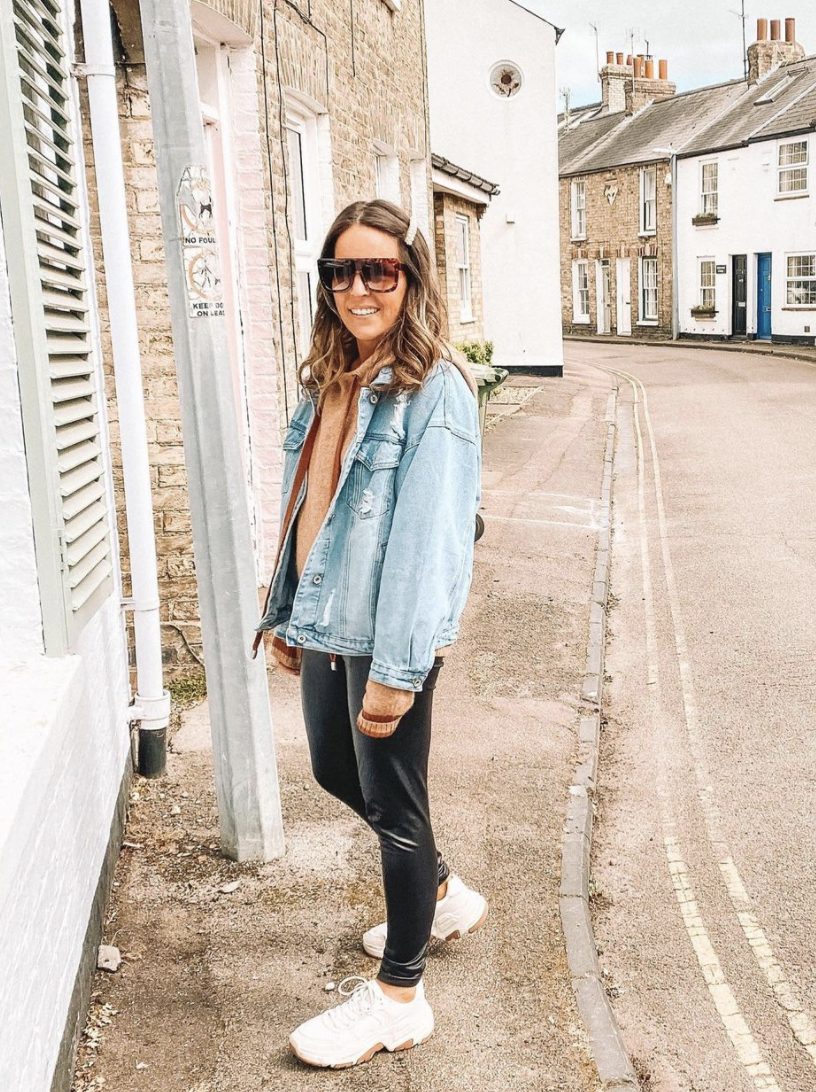 leather leggings with oversized sweatshirt and jean jacket and white sneakers