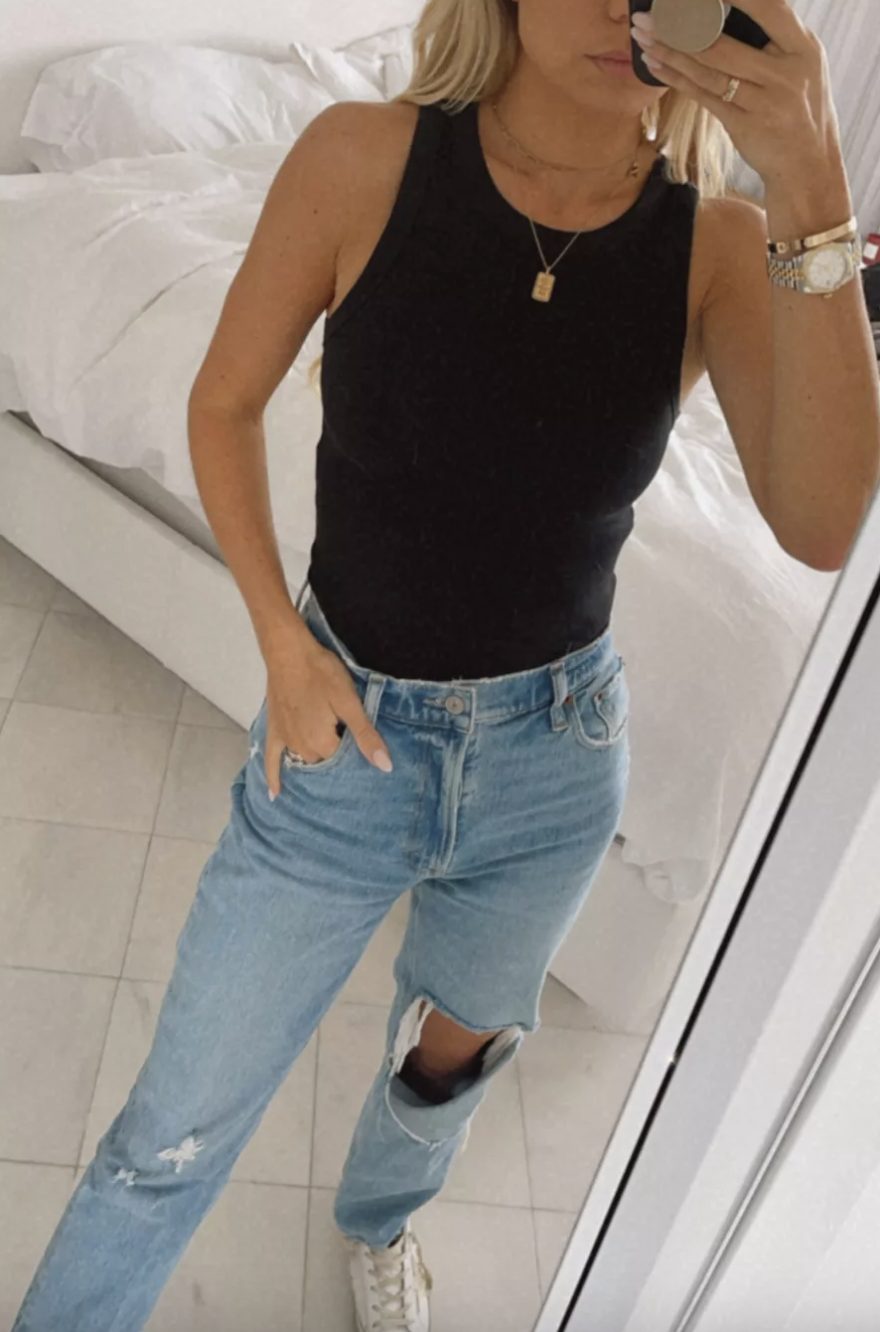 jeans, a black tank, and white sneaker outfit