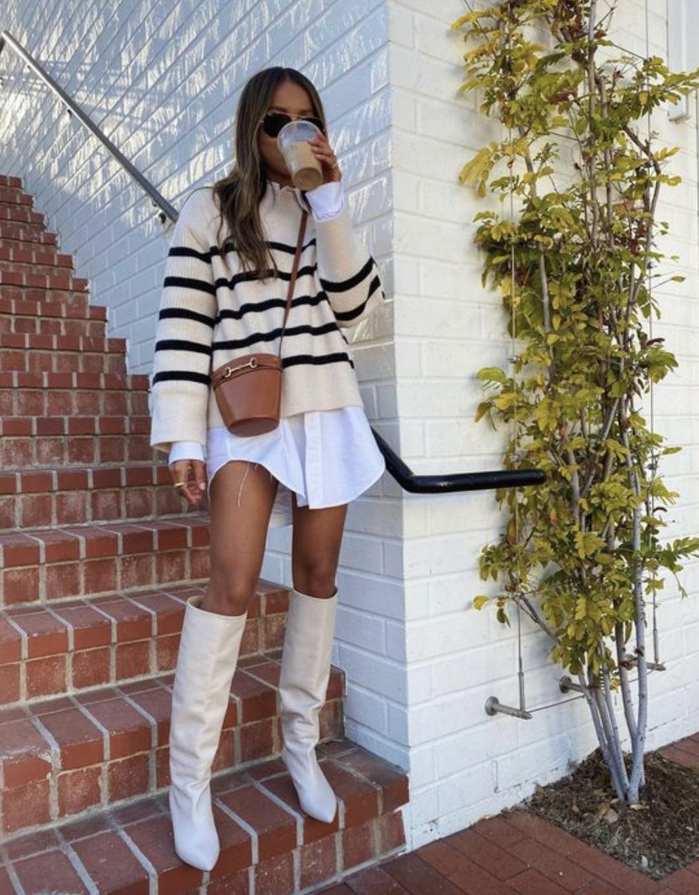 white shirt dress and striped sweater styled with tall white boots