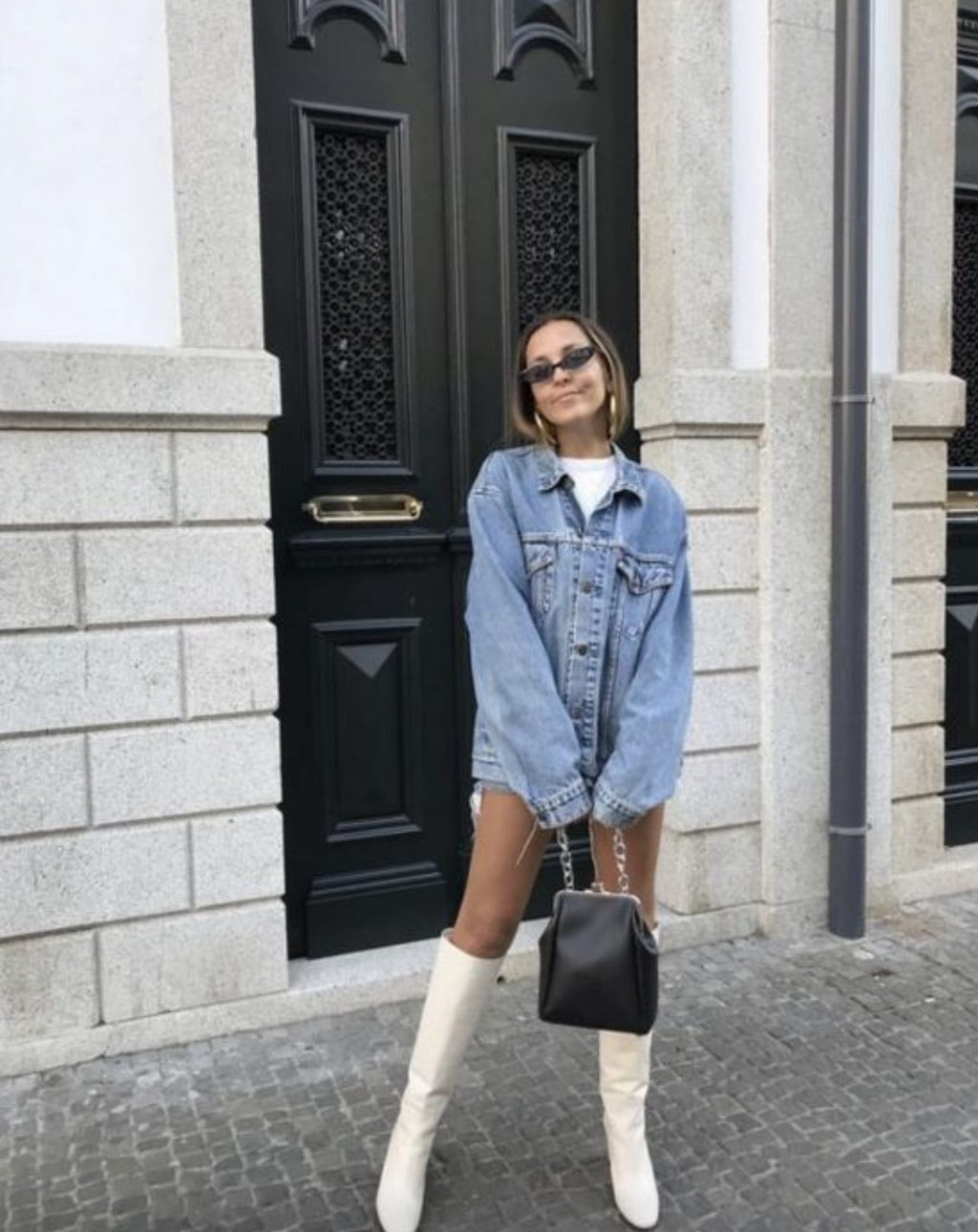 white boots with an oversized denim jacket