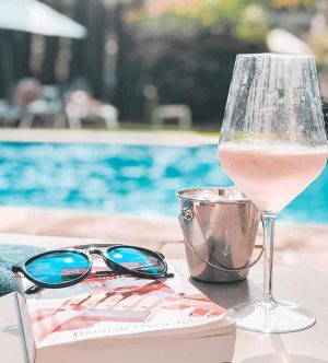 drinks and book by the pool